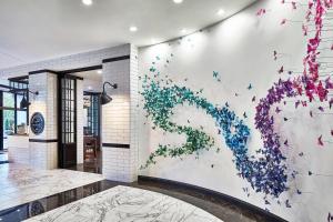 a mural of butterflies on a wall in a building at The Edwin Hotel, Autograph Collection in Chattanooga
