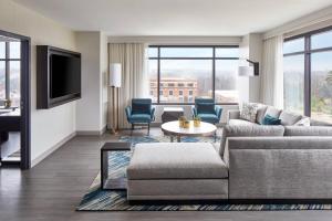 a living room with a couch and a table at UNC Charlotte Marriott Hotel & Conference Center in Charlotte