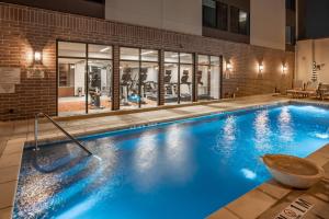 a swimming pool with blue lighting in a building at SpringHill Suites by Marriott Fort Worth Historic Stockyards in Fort Worth