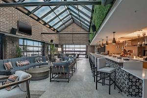 a restaurant with chairs and tables and a bar at SpringHill Suites by Marriott Fort Worth Historic Stockyards in Fort Worth