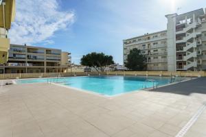 a large swimming pool in the middle of a building at MalagaSuite Carihuela Seaviews in Torremolinos