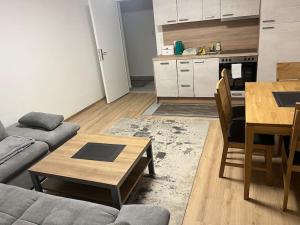 a living room with a couch and a table and a kitchen at Wohnung in Sonnberg