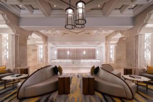 a lobby with couches and tables and a couch at The Ritz-Carlton Orlando, Grande Lakes in Orlando