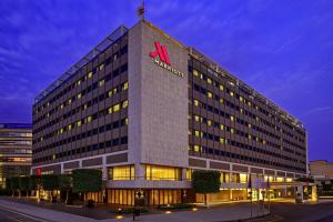 a large building with a m hotel sign on top at Athens Marriott Hotel in Athens