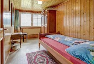 מיטה או מיטות בחדר ב-Ferienwohnung Hautle