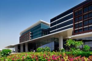 an office building with flowers in front of it at Marriott Hotel Al Forsan, Abu Dhabi in Abu Dhabi