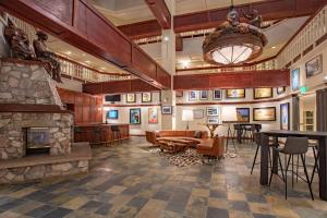 a lobby with a stone fireplace and a chandelier at Beaver Creek Lodge, Autograph Collection in Beaver Creek