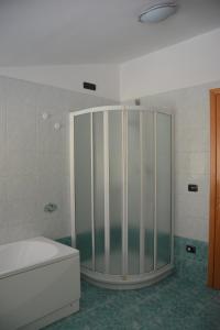 a bathroom with a shower with a tub and a toilet at A. F.antastic V.iew in Costa Volpino