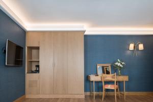 a room with a table and a mirror and a blue wall at Principe Pio in Madrid