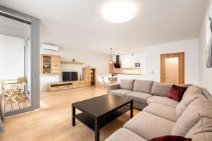 a living room with a couch and a table at Mill Apartments in Brno