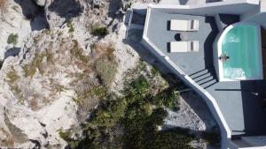 an aerial view of a house with a mountain at Grand View - Megalochori Santorini in Megalokhori