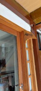 a wooden door with a welcome sign on it at Pousada Charitas Saint Malo in Niterói