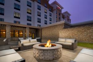a patio with a fire pit in front of a hotel at Courtyard by Marriott Dallas DFW Airport North/Grapevine in Grapevine