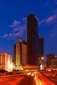 a city skyline at night with a large building at Four Points By Sheraton Kuwait in Kuwait
