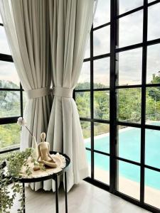 a room with a large window and a table with a statue at The Peak Villa w/ Infinity Pool! (20mins to Clark) 