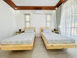 two twin beds in a room with windows at The Peak Villa w/ Infinity Pool! (20mins to Clark) 