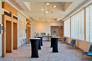 a waiting room with tables and chairs in a building at Marriott Orlando Downtown in Orlando