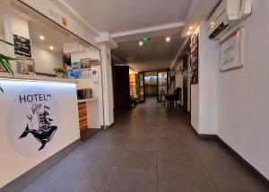 a hallway with a hotel sign on the wall at Hôtel Au Valéry in Sète