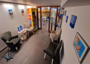 a waiting room with chairs and a table in a building at Hôtel Au Valéry in Sète