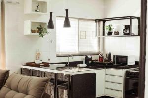 a kitchen with a sink and a counter top at Apartamento em foz do Iguaçu in Foz do Iguaçu