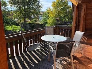 a table and two chairs on a deck with a table at Fewo Pflaumi 1 in Gunzenhausen