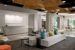 un soggiorno con divano bianco e cuscini blu di Astra Hotel, Seattle, a Tribute Portfolio Hotel by Marriott a Seattle