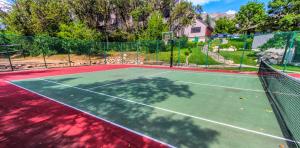 a tennis court with a net on top of it at Wolf Creek Village, a VRI resort in Wolf Creek