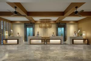 a rendering of a lobby with three people in the mirror at Phuket Marriott Resort & Spa, Merlin Beach in Patong Beach
