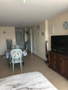a bedroom with a bed and a tv and a chair at Studio pour 2 personnes à Tonnay Charente in Tonnay-Charente