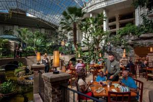 a group of people sitting at tables in a mall at Gaylord Opryland Resort & Convention Center in Nashville