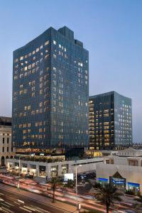 a large building with lights on in a city at Assila, a Luxury Collection Hotel, Jeddah in Jeddah