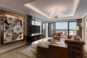 a living room with a couch and a tv at Sheraton Grand Danang Resort & Convention Center in Da Nang