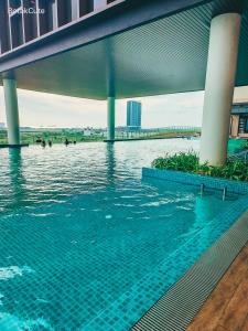 a swimming pool with people in the water at BotakCuteHomestay@BaliResidence in Melaka