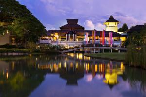 a building with a bridge over a body of water at Le Meridien Chiang Rai Resort, Thailand in Chiang Rai