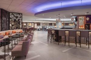 a bar in a restaurant with chairs and a counter at Minneapolis Marriott City Center in Minneapolis