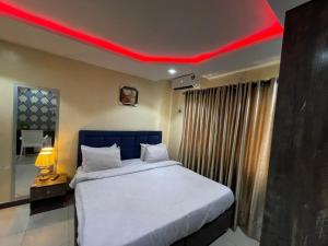 a bedroom with a bed with a red ceiling at Suite Subzero in Lagos