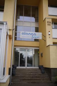 a building with a sign on the front of it at Alanga apartament in Palanga