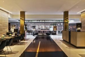 a hotel lobby with a bar and a restaurant at Le Méridien Vienna in Vienna