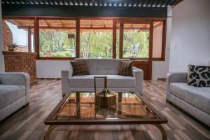 Sala de estar con 2 sofás y mesa de centro en Bombon spa destination, en Villa de Leyva