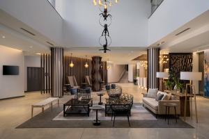 a lobby with a couch and chairs and a table at Protea Hotel by Marriott Johannesburg Wanderers in Johannesburg