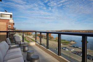 a balcony with a view of a city and a highway at The Merrill Hotel & Conference Center, Muscatine, a Tribute Portfolio Hotel in Muscatine
