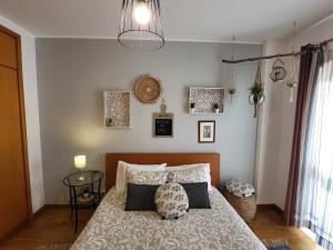 een slaapkamer met een bed met kussens erop bij Terrace Porto Downtown in Porto