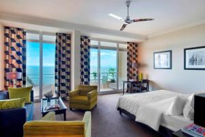a bedroom with a bed and a view of the ocean at Le Méridien Beach Plaza in Monte Carlo
