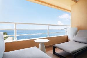 a room with a large window with a view of the ocean at Le Méridien Beach Plaza in Monte Carlo