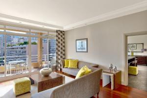 a living room with a couch and a table at Le Méridien Beach Plaza in Monte Carlo