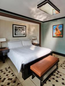 a bedroom with a large white bed and two tables at 45 Park Lane - Dorchester Collection in London