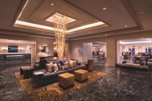 a living room with a couch and a chandelier at The Ritz-Carlton, Marina del Rey in Los Angeles