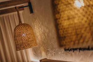a lamp hanging from a wall next to a window at Renaissance Wind Creek Aruba Resort in Oranjestad