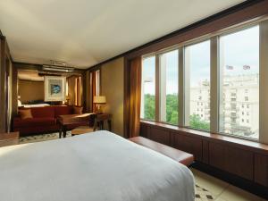 a hotel room with a large bed and windows at 45 Park Lane - Dorchester Collection in London