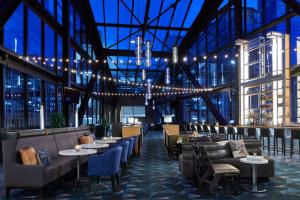 a restaurant with couches tables and chairs and lights at Renaissance Nashville Hotel in Nashville